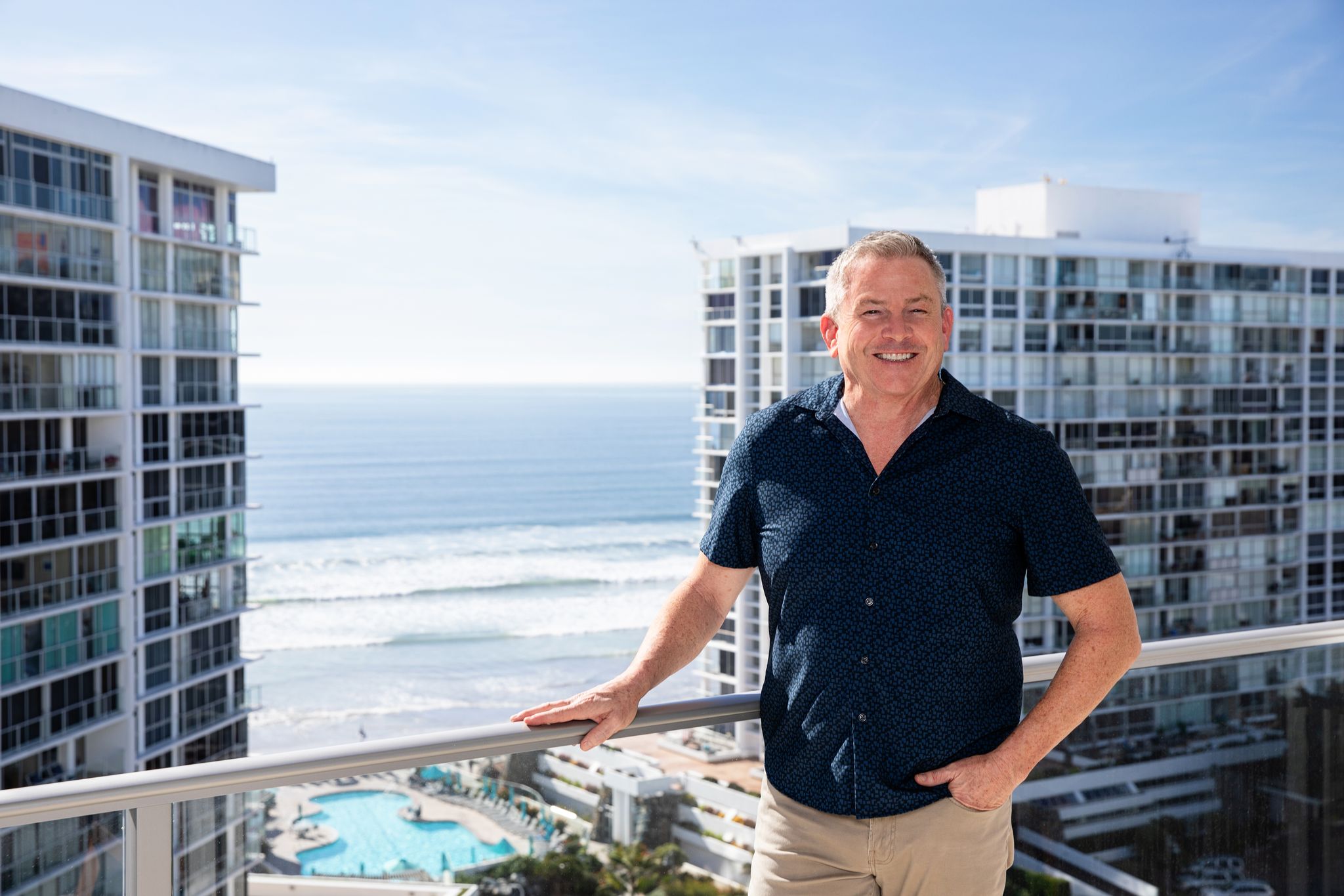 Tom Tilford, Coronado Shores real estate specialist, on a tower balcony above the ocean